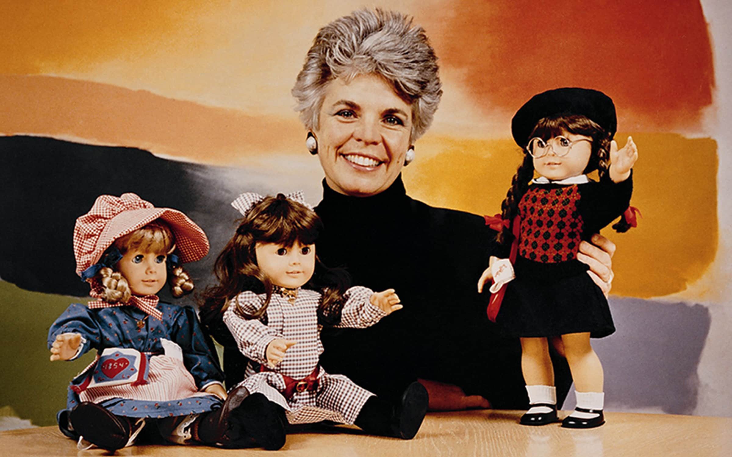 Image of Pleasant Rowland with original Kirsten, Samantha, and Molly dolls